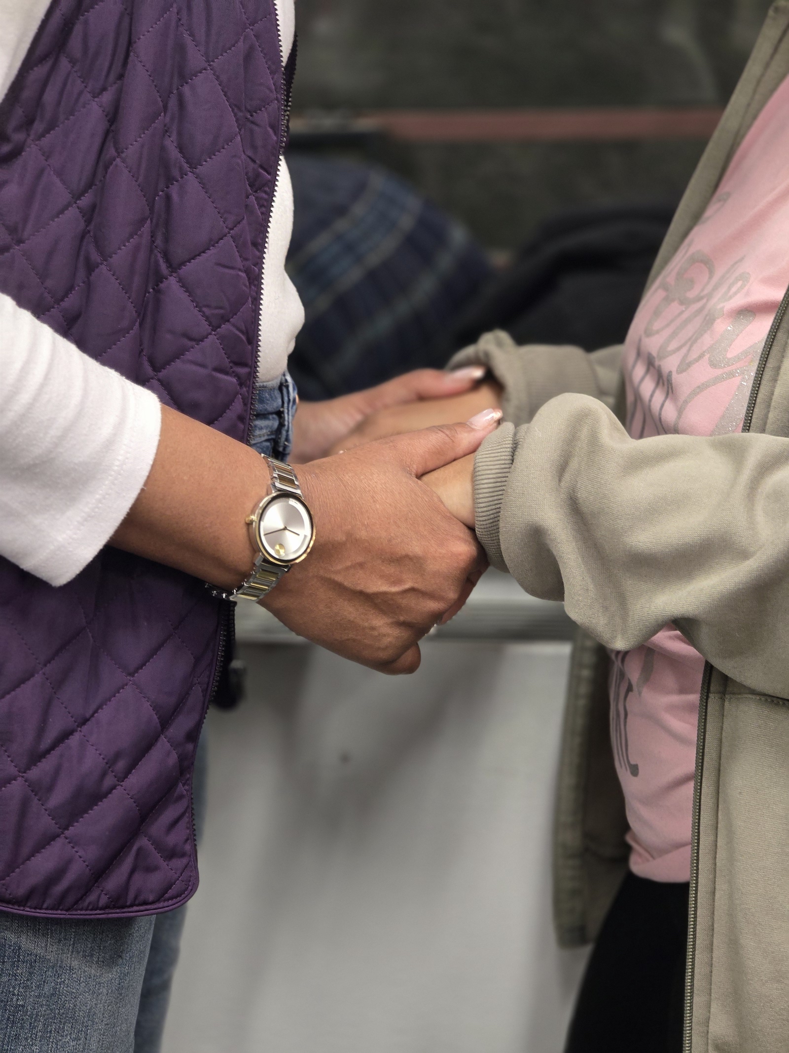 pair of hands holding another pair of hands